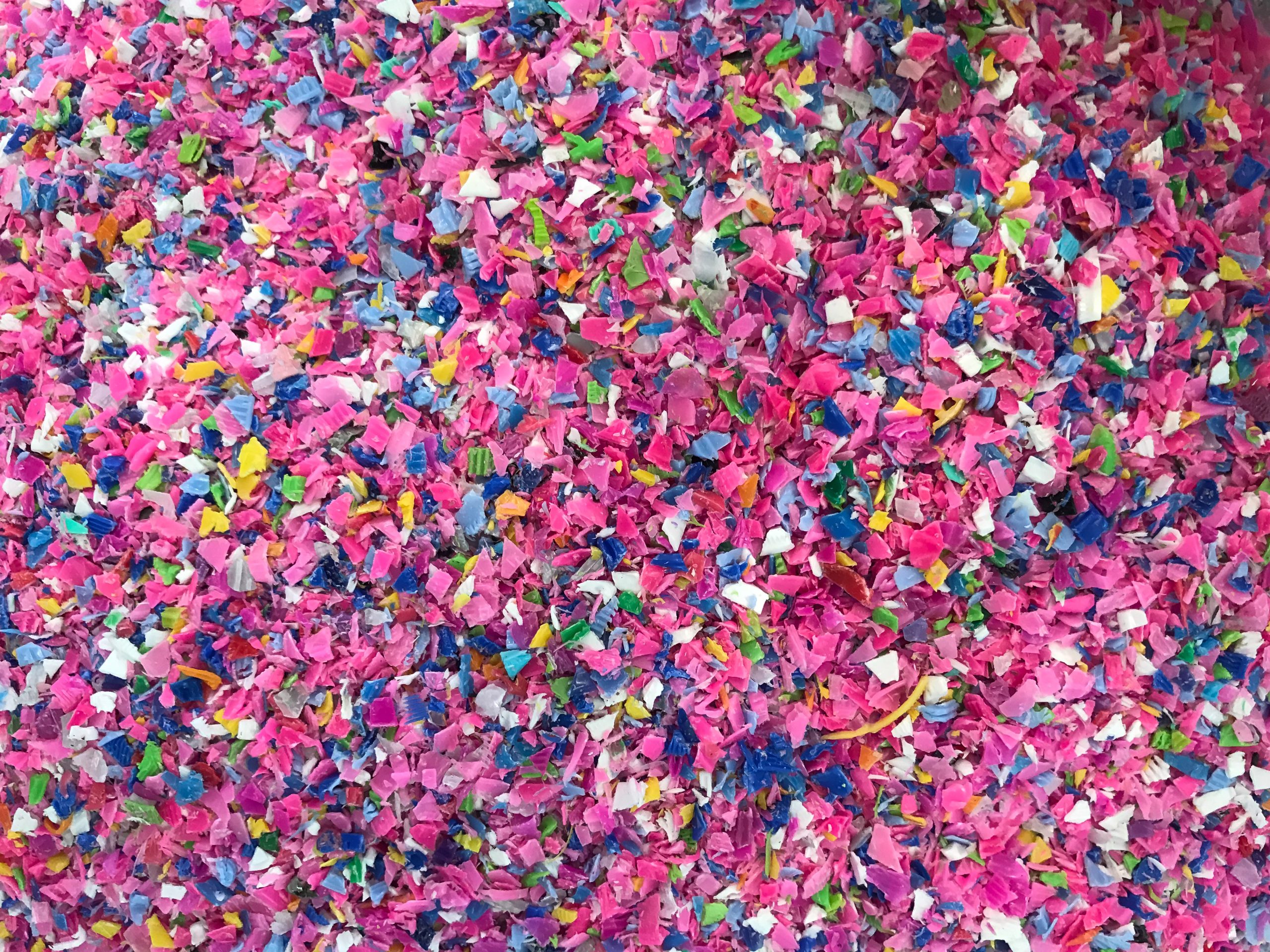 Crushed plastic granules for recycling. Plastic crusher. Recycled plastic with mixed colors. The concept of recycled plastic used